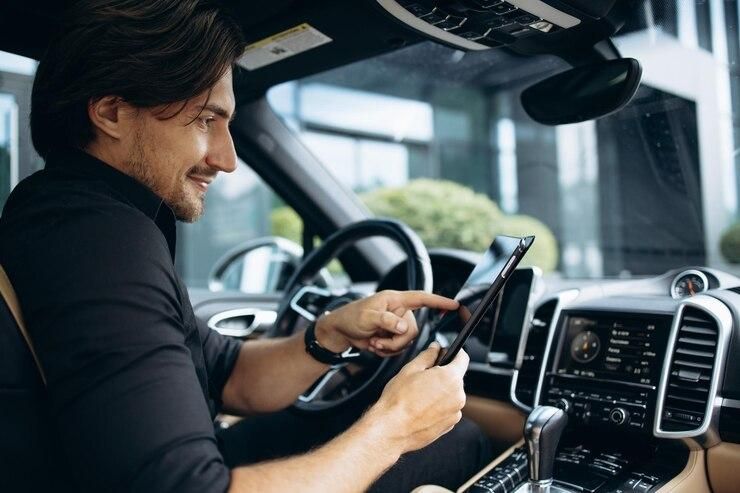 handsome-business-man-working-tablet-his-car_732190-2637.jpg