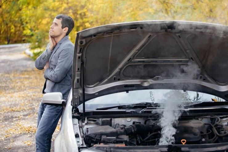 man-looks-open-hood-car-car-broke-down-road-engine-is-smoking_213607-1704.jpg