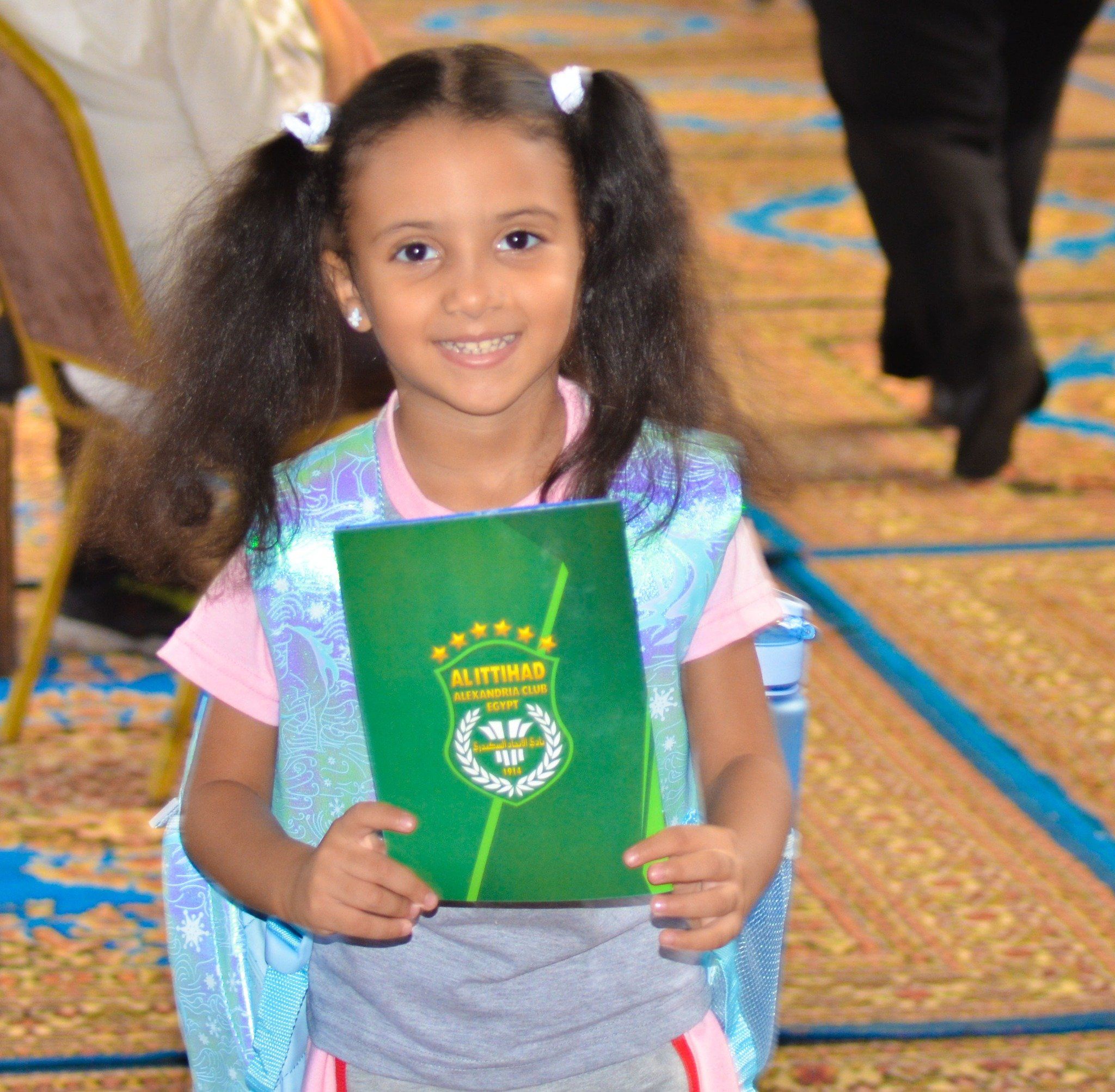 طفلة تحمل كراسة اللائحة الجديدة طفلة تحمل كراسة اللائحة الجديدة