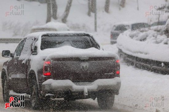 الثلج يكتسى السيارات الثلج يكتسى السيارات